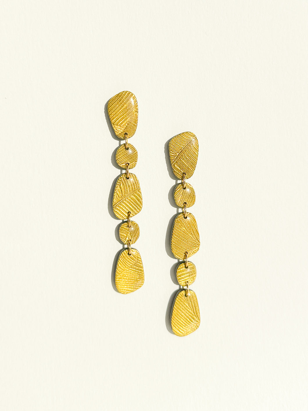 Pebble Drops | gold palm leaf